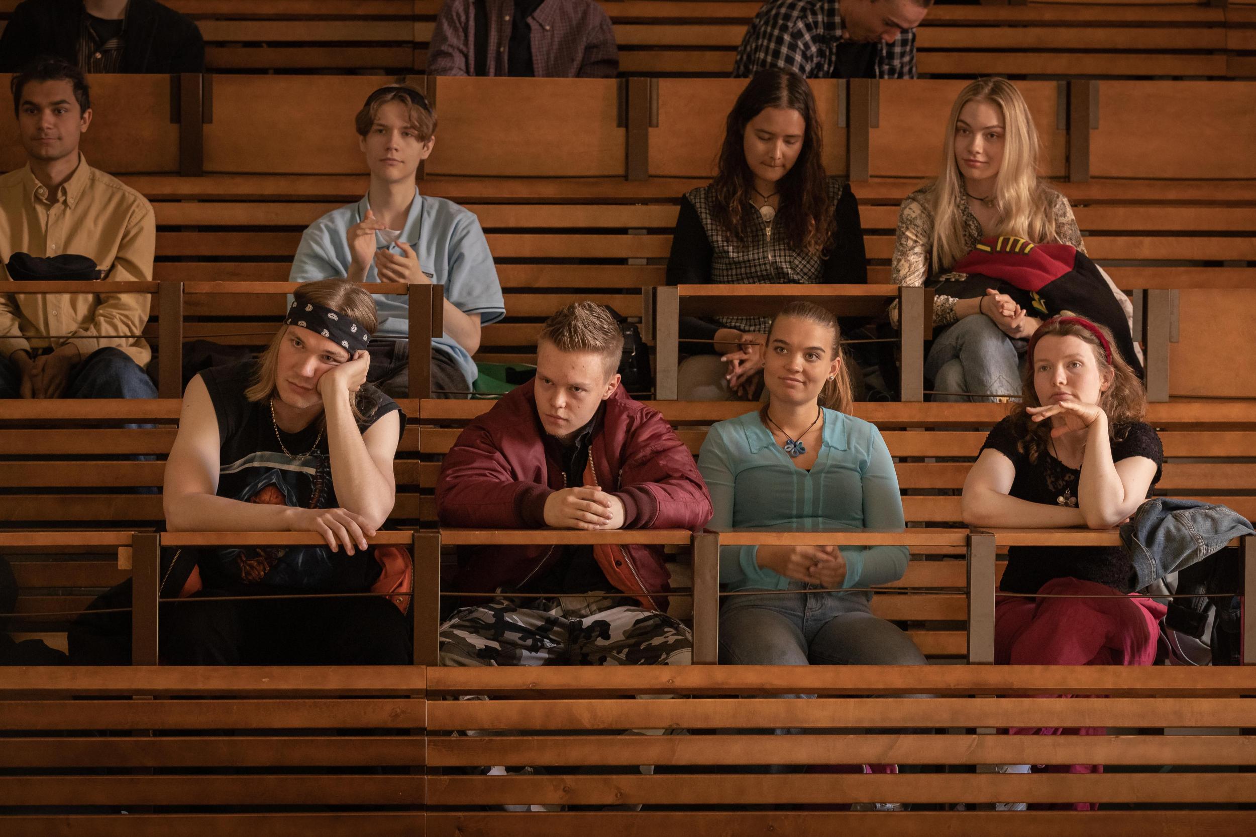 The young cast of Tuurenmäki 98 sitting on school bleachers